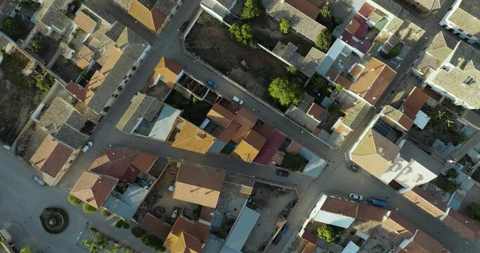 Aerial view of traditional European village with geometric patterns and greenery, San Clemente, Cuenca, Spain.