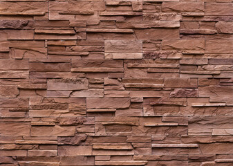 The walls are decorated with tiles made from natural red-brown sandstone.