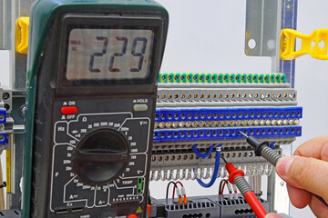 Measurement of electrical circuit parameters using a multimeter in an electrical switchboard.	
