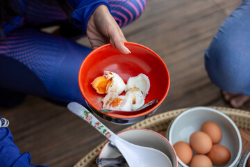 Selective focus boiled chicken eggs sprinkled with pepper in an orange cup A delicious, simple,...