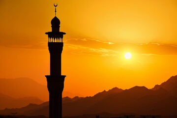 Tranquil golden sunset Silhouette of Islamic minaret under the serene evening sky