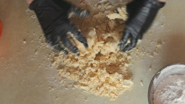 Mixing shortbread dough on the table. Mixing butter and dough until a thick homogeneous mass is formed