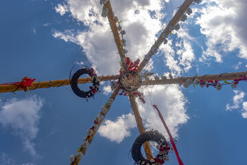 poles easter with flower decoration looking up at the sky