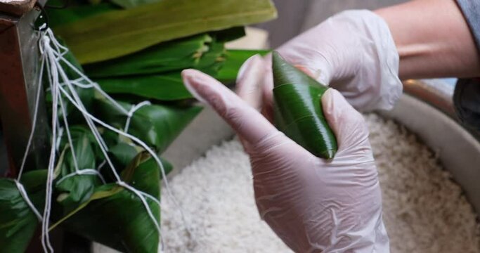 making Zongzi (rice dumpling or sticky rice dumpling). traditional Chinese food in Dragon Boat Festival