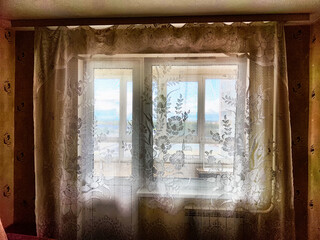 Morning Light Filtering Through Lace Curtains in a Cozy Room. Chiffon curtain on the window in the...