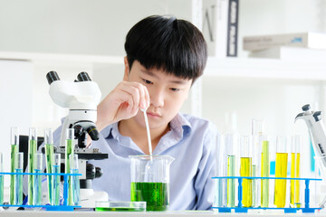 boy doing science experiment science classroom.