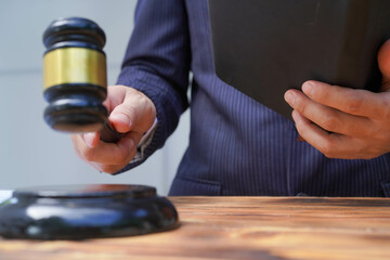 Male lawyer working with contract documents and Justice and law, lawyer, court judge, concept.