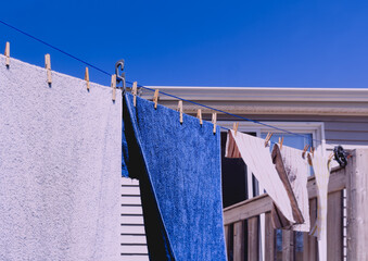 Towels drying on a clothes or laundry line during a sunny day. Vintage look.