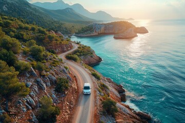 White car driving on a winding coastal road with stunning ocean views