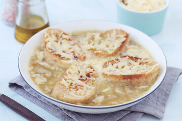 A ceramic bowl with French onion soup