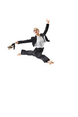Professional woman in business suit executing perfect leap, holding her shoes aloft against white...