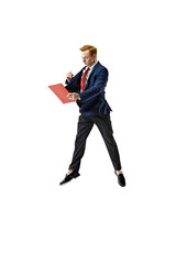 Young business man in formal attire in dynamic pose holding and reading red document folder against...
