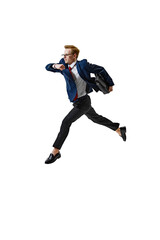 Young man fast running, leaping in motion holding briefcase against white studio background....
