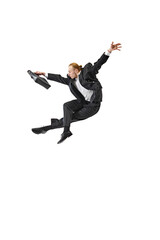 Business professional in suit performing dynamic leap. Swift and decisive movements required for...