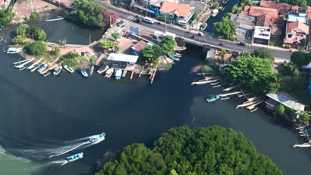 Aerial view of Negombo Lagoon with boats, houses, and bridge, Negombo, Sri Lanka.