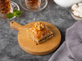 Walnut baklava. Traditional Middle Eastern Flavors. Traditional Turkish baklava. fistikli baklava with Turkish tea on dark background