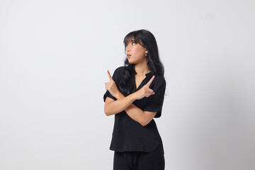 Portrait of excited Asian woman in casual shirt spreading hands making choice, choosing between two objects. Businesswoman concept. Isolated image on white background