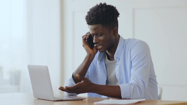 Call to support. Worried guy with broken laptop calling to maintenance service from home