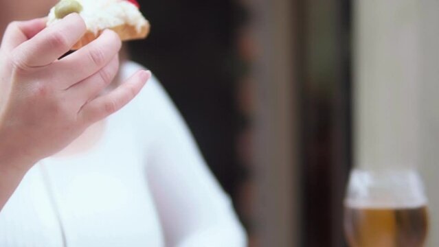 A tourist eats a piece of toast with a look of pleasure