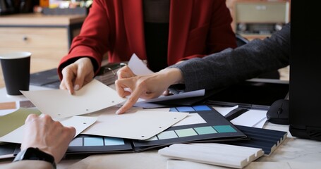 Architect designer and builder discuss color selection. Female team explores range of palettes encouraging open dialogue and brainstorming during meeting. Women leaders, ideas and collaborative