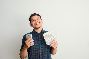 Man cheerful smile with mobile phone and a lot of money in hand