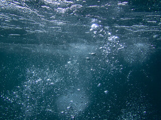 Bubbles under the sea in the crystal clear green sea water. Mediterranean bubbles. Real image very...