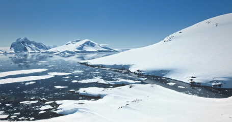 Amazing snow covered Antarctic nature beauty. Mountain range, polar ocean, frozen glacier, penguins...