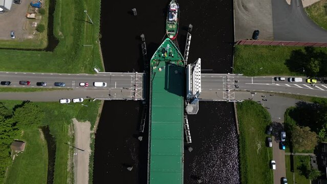 Aerial video over a river in Appingedam  Netherlands on passing cargo ships