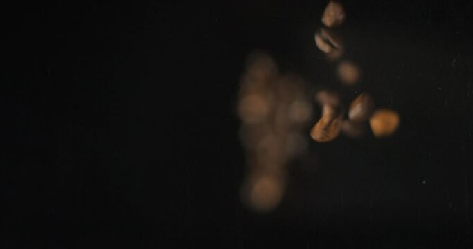 Coffee beans falling from below, slowmotion low angle 4K pro res