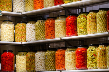 Shelves full of glass jars filled with various food items