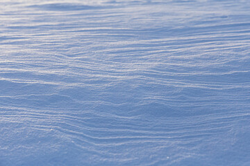 wind blown textured snow covers ground