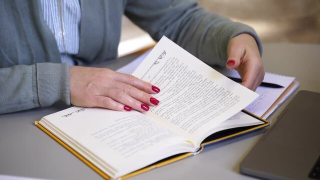 Middle aged woman scientist reading book write thesis in university library Mature student exercising in college Freelancer in coworking upgrading professional qualification