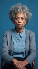 Azure background sad black American independent powerful Woman. Portrait of older mid-aged person beautiful bad mood expression girl Isolated on Background racism skin color depression anxiety 