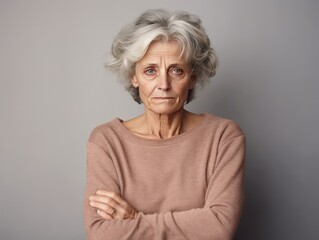 Beige background sad European white Woman grandmother realistic person portrait of young beautiful bad mood expression Woman Isolated Background depression