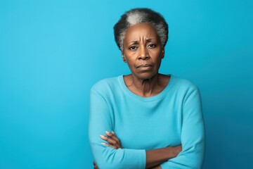 Blue background sad black American independent powerful Woman. Portrait of older mid-aged person beautiful bad mood expression girl Isolated on 