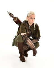 full length portrait of blonde female model wearing green fantasy elf warrior halloween costume...