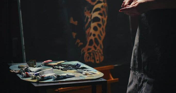 Woman Examines Leopard Painting