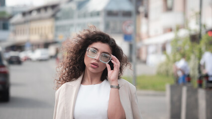 Stylish beautiful woman portrait in summer on city street