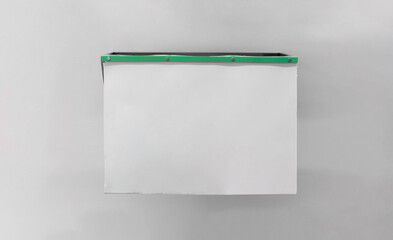 Mockup of a blank poster made of silicone material, screwed and attached to a wall with a smooth background