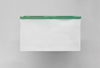 Mockup of a blank poster made of silicone material, screwed and attached to a wall with a smooth...