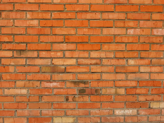 A brick wall with a red color