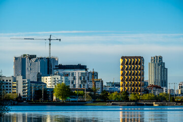 A tall tower crane on the construction of urban buildings.