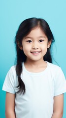 Cyan background Happy Asian child Portrait of young beautiful Smiling child good mood Isolated on backdrop ethnic diversity equality acceptance concept with copyspace