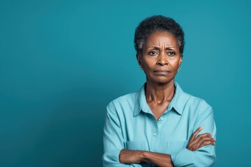 Cyan background sad black American independent powerful Woman. Portrait of older mid-aged person beautiful bad mood expression girl Isolated on Background racism skin color depression anxiety fear bur