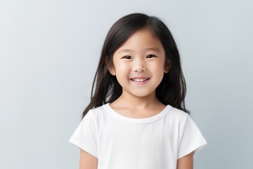 Gray background Happy Asian child Portrait of young beautiful Smiling child good mood Isolated on backdrop ethnic diversity equality acceptance 