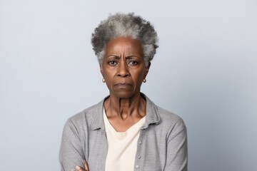 Ivory background sad black American independent powerful Woman. Portrait of older mid-aged person beautiful bad mood expression girl Isolated 