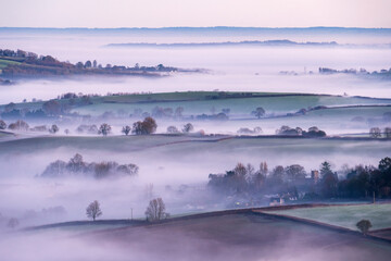 Frosty and misty winter sunrise from Pilsdon Pen, looking across Marshwood Vale.  Dorset, UK. January.  
