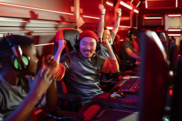 Excited gamers celebrating victory at a gaming tournament
