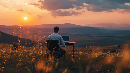A man working on a laptop in nature. The concept of work-life balance or a freelancer concept.