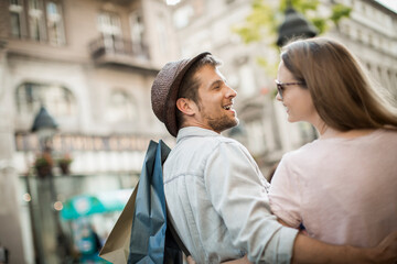 Happy couple shopping together in the city